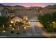 Charming single-story home with desert landscaping, attached garage, and mountain views at sunset at 27203 N 78Th Ln, Peoria, AZ 85383