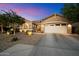 Charming home exterior with a well-maintained front yard and a two-car garage at twilight at 27203 N 78Th Ln, Peoria, AZ 85383
