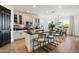 Open concept kitchen with a large island, sleek countertops, and modern appliances, attached to the dining room at 27203 N 78Th Ln, Peoria, AZ 85383