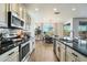 Contemporary kitchen showcasing granite countertops, sleek cabinetry, and stainless steel appliances at 27203 N 78Th Ln, Peoria, AZ 85383
