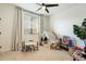 Bright playroom with a table and chairs, playhouse, and organized toy storage at 27203 N 78Th Ln, Peoria, AZ 85383