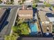 Aerial view of home and backyard, featuring a pool, covered patio, and lush landscaping at 27316 N Covered Wagon Rd, Phoenix, AZ 85085