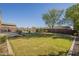 Spacious backyard with lush green lawn, mature trees and landscaping at 27316 N Covered Wagon Rd, Phoenix, AZ 85085