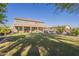 Expansive backyard view with a covered patio, pool and green lawn at 27316 N Covered Wagon Rd, Phoenix, AZ 85085