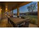 Spacious covered patio overlooking an outdoor kitchen, pool, and landscaped backyard at 27316 N Covered Wagon Rd, Phoenix, AZ 85085