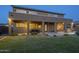Inviting covered patio with outdoor kitchen and view of pool and landscaped backyard at 27316 N Covered Wagon Rd, Phoenix, AZ 85085