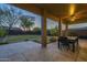 Relaxing covered patio with a ceiling fan and serene backyard view at 27316 N Covered Wagon Rd, Phoenix, AZ 85085