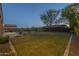Expansive backyard showcasing a pool, lush lawn, mature trees, and patio at 27316 N Covered Wagon Rd, Phoenix, AZ 85085