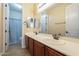 Bright bathroom featuring a double vanity, ample storage, and tile flooring at 27316 N Covered Wagon Rd, Phoenix, AZ 85085