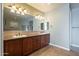 Bathroom vanity area with dual sinks, granite counters, and updated lighting at 27316 N Covered Wagon Rd, Phoenix, AZ 85085