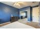 Bright bedroom features blue walls, a mirrored closet, and ample natural light at 27316 N Covered Wagon Rd, Phoenix, AZ 85085