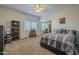 Spacious bedroom featuring a large bed, mirrored closet, and bookshelf by the window at 27316 N Covered Wagon Rd, Phoenix, AZ 85085