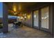 Inviting covered patio with a ceiling fan and double doors overlooking backyard at 27316 N Covered Wagon Rd, Phoenix, AZ 85085