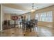 An eat in kitchen nook with dark wood table and chairs; open floor plan overlooks the living room at 27316 N Covered Wagon Rd, Phoenix, AZ 85085