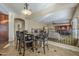 An eat in kitchen nook with dark wood table and chairs; open floor plan overlooks the living room at 27316 N Covered Wagon Rd, Phoenix, AZ 85085
