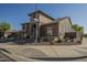 Stunning two-story home featuring a stone archway, desert landscaping, and tile roof in a quiet neighborhood at 27316 N Covered Wagon Rd, Phoenix, AZ 85085