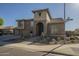 Beautiful two-story home with a stone archway entrance, desert landscaping, and a three-car garage at 27316 N Covered Wagon Rd, Phoenix, AZ 85085