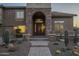 Charming front entrance with stone archway, custom door, and desert landscaping at 27316 N Covered Wagon Rd, Phoenix, AZ 85085