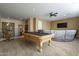 Spacious game room featuring a pool table, plush seating, and a ceiling fan at 27316 N Covered Wagon Rd, Phoenix, AZ 85085