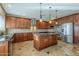 Gourmet kitchen features sleek stainless steel appliances, granite countertops, and custom wood cabinetry at 27316 N Covered Wagon Rd, Phoenix, AZ 85085