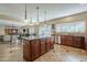 Open concept gourmet kitchen with a large center island adjacent to an eat in kitchen nook at 27316 N Covered Wagon Rd, Phoenix, AZ 85085