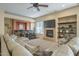 Comfortable living area with a fireplace, built-in shelves, and a stylish wet bar for entertaining at 27316 N Covered Wagon Rd, Phoenix, AZ 85085