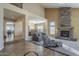 A cozy living room features a soaring stacked stone fireplace, large windows and elegant decor at 27316 N Covered Wagon Rd, Phoenix, AZ 85085