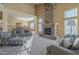 A spacious living room offers a stone fireplace and seamless flow to the dining area at 27316 N Covered Wagon Rd, Phoenix, AZ 85085