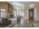Inviting living room with high ceilings, a stone fireplace, and ample natural light at 27316 N Covered Wagon Rd, Phoenix, AZ 85085