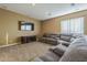 Comfortable living room with a large sectional sofa, TV, and window at 27316 N Covered Wagon Rd, Phoenix, AZ 85085