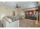 Spacious living room with plush carpet, a large sectional sofa, and a built-in bar area at 27316 N Covered Wagon Rd, Phoenix, AZ 85085