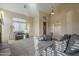 This living room is bathed in natural light, showcasing stylish furniture and a view of the entryway at 27316 N Covered Wagon Rd, Phoenix, AZ 85085