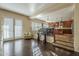 Open concept living area leading to the kitchen with hardwood floors and decorative railing at 27316 N Covered Wagon Rd, Phoenix, AZ 85085