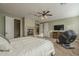 Spacious primary bedroom featuring a fireplace, lounge chair, and a TV at 27316 N Covered Wagon Rd, Phoenix, AZ 85085