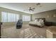 Serene main bedroom with large windows, a ceiling fan, and lots of floor space at 27316 N Covered Wagon Rd, Phoenix, AZ 85085