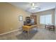 A well-lit home office with a large wooden desk and ample storage at 27316 N Covered Wagon Rd, Phoenix, AZ 85085