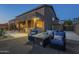 A covered patio with a built-in bar, seating area, and a fire pit, perfect for outdoor gatherings at 27316 N Covered Wagon Rd, Phoenix, AZ 85085