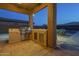 A covered outdoor kitchen with a built-in grill, perfect for outdoor cooking and entertaining guests at 27316 N Covered Wagon Rd, Phoenix, AZ 85085