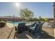 Backyard with lounge chairs, a pool, built in bar, and a fire pit at 27316 N Covered Wagon Rd, Phoenix, AZ 85085
