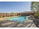 Backyard pool featuring a tanning ledge and chairs at 27316 N Covered Wagon Rd, Phoenix, AZ 85085