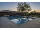 A backyard pool area, surrounded by a tiled patio, with lounge chairs and a hammock for relaxation at 27316 N Covered Wagon Rd, Phoenix, AZ 85085