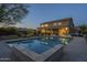 A backyard pool and patio area at dusk, perfect for relaxation and entertaining at 27316 N Covered Wagon Rd, Phoenix, AZ 85085