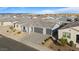 Aerial view of a home with three-car garage and landscaping in a suburban neighborhood at 3187 E Pineapple Rd, San Tan Valley, AZ 85143