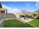 Beautiful backyard with green grass, pavers, desert landscaping, and privacy fence at 3187 E Pineapple Rd, San Tan Valley, AZ 85143
