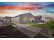 Landscaped backyard features green grass and a covered patio perfect for outdoor living at 3187 E Pineapple Rd, San Tan Valley, AZ 85143