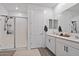 A modern bathroom with glass enclosed shower and double vanity at 3187 E Pineapple Rd, San Tan Valley, AZ 85143