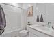 A bright bathroom with all-white fixtures and framed animal art at 3187 E Pineapple Rd, San Tan Valley, AZ 85143