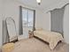 Minimalist bedroom with a twin bed, a large window, and a full-length mirror at 3187 E Pineapple Rd, San Tan Valley, AZ 85143