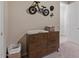 A bedroom featuring a changing table and unique bike decor at 3187 E Pineapple Rd, San Tan Valley, AZ 85143