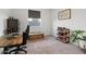 A functional bedroom with a desk, a rolling office chair, and rustic-style shelving at 3187 E Pineapple Rd, San Tan Valley, AZ 85143